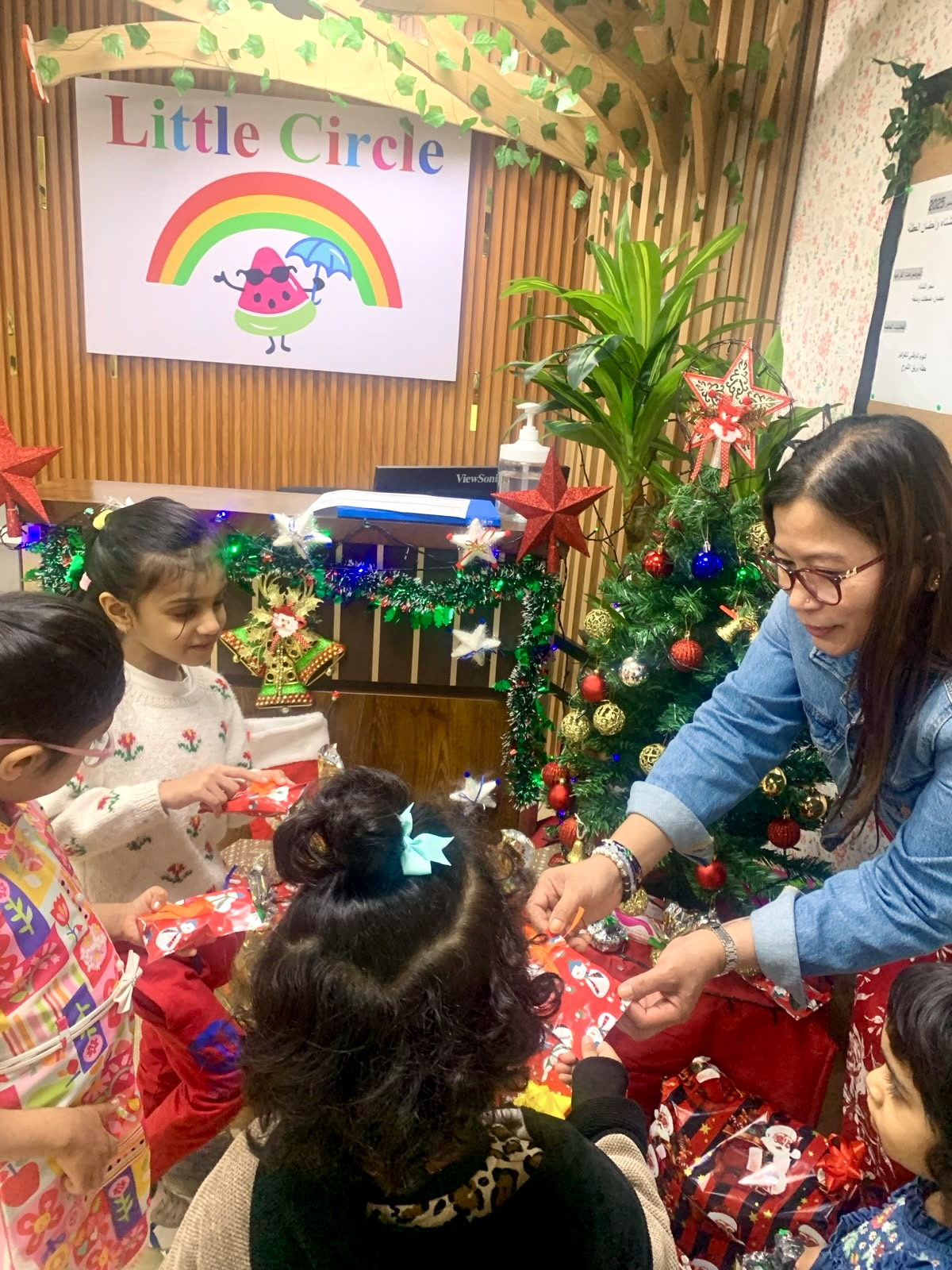 Children and their teachers at a decorated Little Circle celebration corner