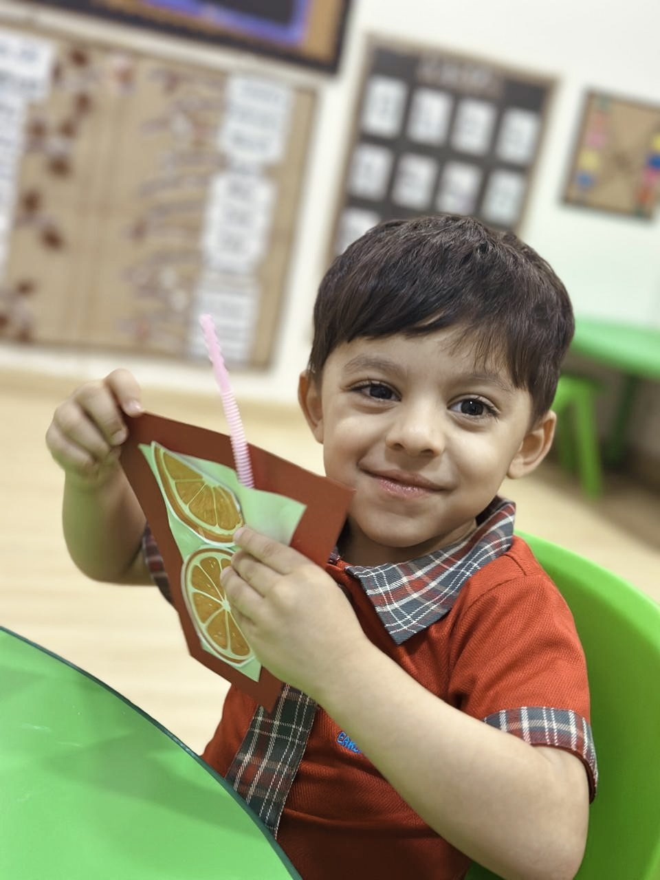 A child proudly showing a painting they have finished