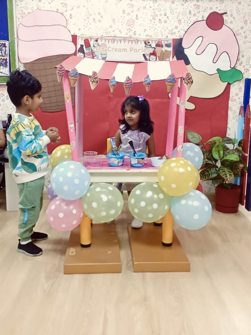 Children playing in a decorated pretend cafe corner